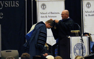 Richard Rose presents John McKeegan with the presidential medallion