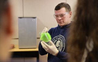 Students collect evidence in the crime scene lab.