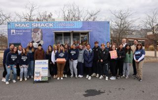 Mount Aloysius student, faculty, and staff volunteers gather at the end of the "Stuff the MAC Shack Mobile Food Truck" food drive on the Mount Aloysius College campus Friday, November 14.