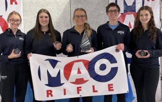 The Mountie rifle team holds the trophies they received for being back-to-back conference champions.