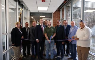 Members of the Mountie community, members of the Board of Trustees, and state and local representatives cut the ribbon on the Student Veteran Lounge.