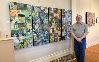 Dr. Don Talbot stands beside his piece, 'L’heure bleue' (2025, ink on textile mounted on canvas), in the Wolf-Kuhn Gallery at Mount Aloysius College.